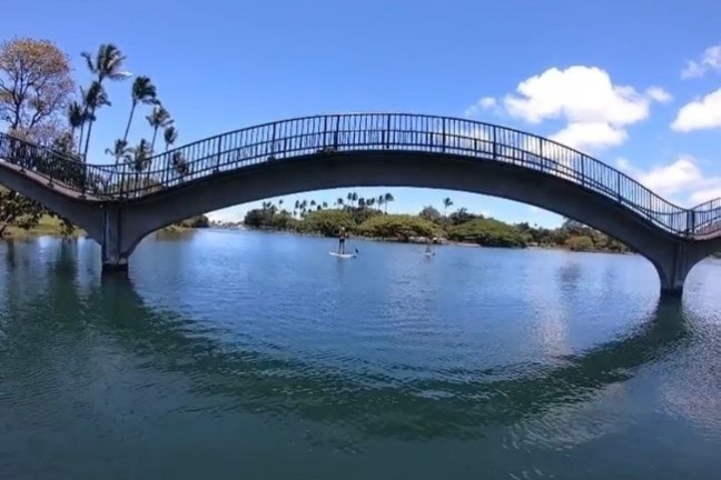 a train crossing a bridge over a body of water