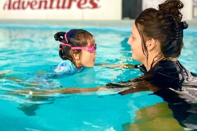 a person swimming in a pool of water